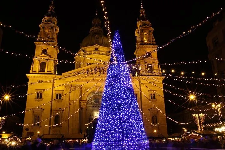 St Stephen's Basilica lit up behind its market on a Budapest Christmas market tour