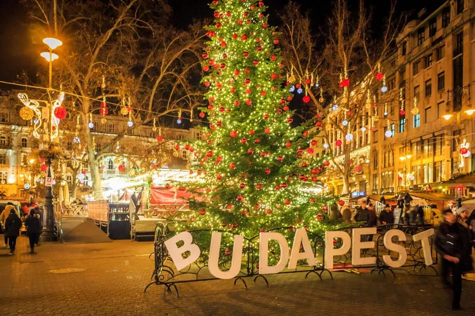 Chimney cakes turning over coals at a stall on a Budapest Christmas market tour