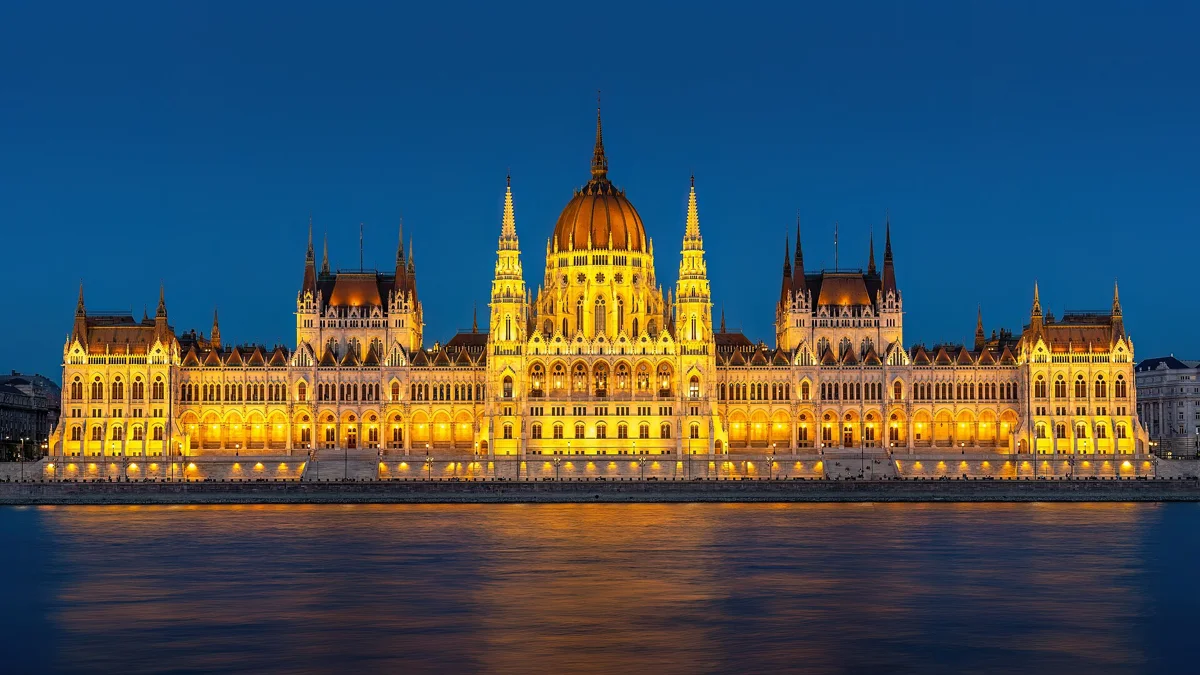 The Hungarian Parliament on the Danube at blue hour, a sight on the Budapest Christmas tour with folk music