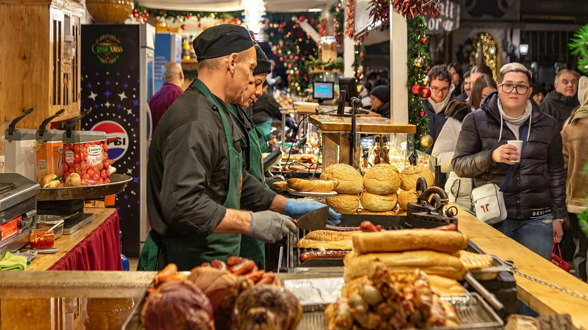 A busy stall at the Vörösmarty Square Christmas market on a Budapest Christmas markets tour with chimney cake